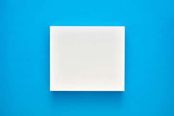 White blank square shape or frame on blue background