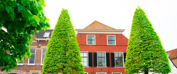 orange house with shutters in Maasland, The Netherlands
