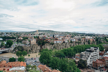 Fototapeta na wymiar Panoramic view of the city of Tbilisi from the Narikala fortress, the old city and modern architecture. Tbilisi is the capital of Georgia