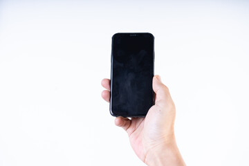 Isolated shot of a man's hand holding a mobile phone