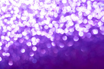 Purple glitter foil background. Shiny metal purple foil texture abstract defocused background. Sparkle glitter texture with bokeh lights