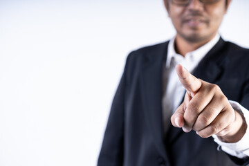 Closed up shot of an asian men pointing at the camera wearing a suit