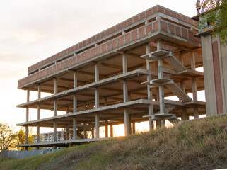 Building under construction with 4 floors at sunset
