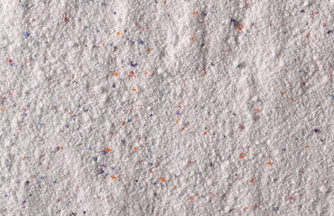 Washing powder with colorful granules, detergent background and texture