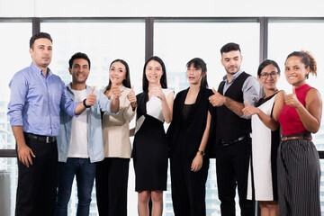 Successful business people with team product thumbs up and smiling for success stategies