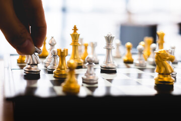Leading strategy of successful business leader, hand on business moving chess in competition to success