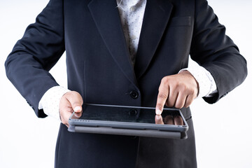 Closed up shot of a man in suit holding a tablet