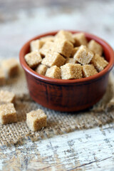 Brown sugar cubes in a bowl. Sugar for mojito cocktail. Healthy diet. Stop diabetes concept.