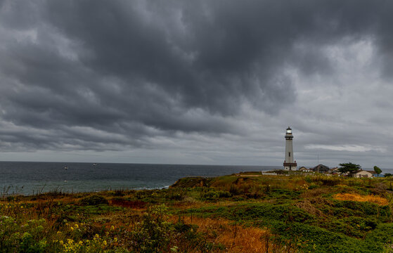 Pigeon Point Lighthouse with a very ominous dark cloud coming in from the Pacific ocean