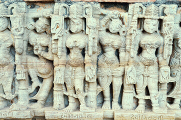 white marble bas-relief with a pattern of women on the temple wall, India