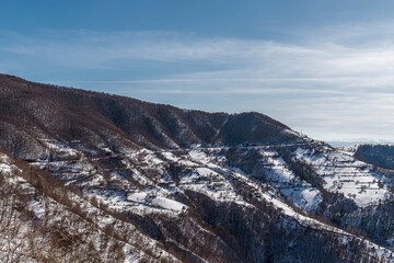 Snowy mountain ridge, chalet, mountain road