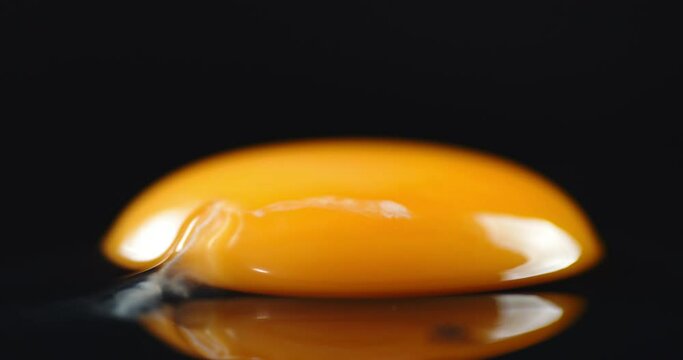 A raw egg without the shell on the table slowly rotates.
