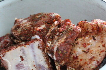 preparation of pork meat on the ribs with spices Provencal herbs for frying