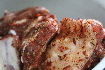 preparation of pork meat on the ribs with spices Provencal herbs for frying