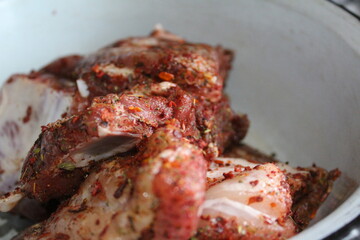 preparation of pork meat on the ribs with spices Provencal herbs for frying