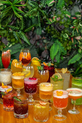 Set of alcoholic cocktails on the wooden table.