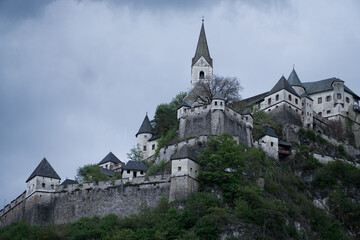 Fototapeta na wymiar Mysterious castle in Austria with cloudy gloomy sky