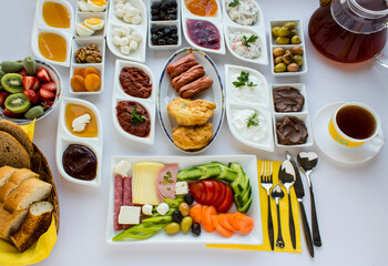 Traditional Turkish breakfast on the white table with fresh fruits and tea.Top and large view