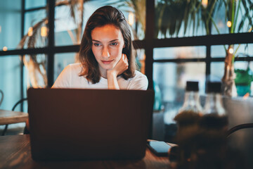 female girl using laptop at cafe workplace, hipster freelancer typing on keyboard  laptop indoors restaurant, business woman working via portable computer internet technology