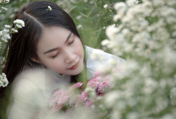 Beautiful Vietnamese girl in a flower garden