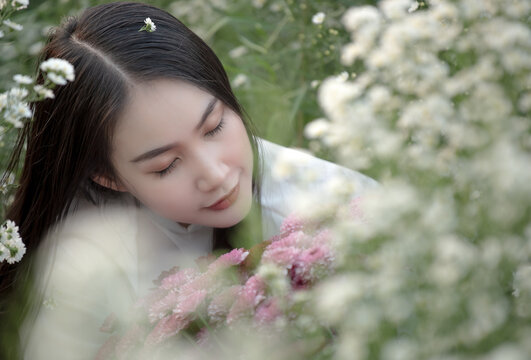 Beautiful Vietnamese girl in a flower garden