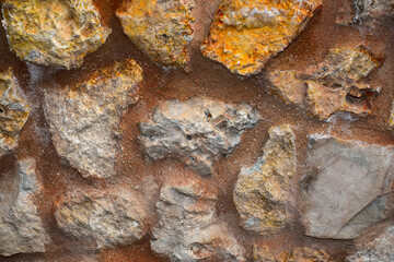 Natural raw stone in an ancient wall.