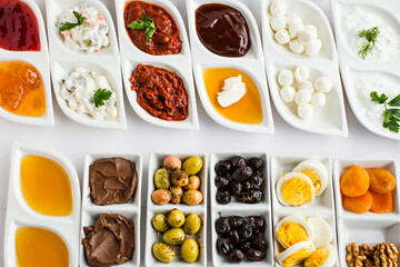 Traditional Turkish breakfast,in luxury porcelain,breakfast plates,designed on the white surface,buffet style.Top view