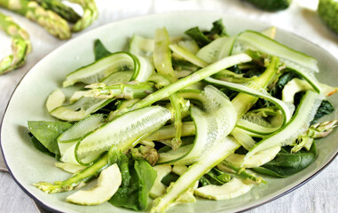 salad of asparagus and cucumber shavings and spinach, thin slices of vegetables with olive oil