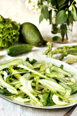 salad of asparagus and cucumber shavings and spinach, thin slices of vegetables with olive oil