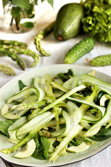 salad of asparagus and cucumber shavings and spinach, thin slices of vegetables with olive oil