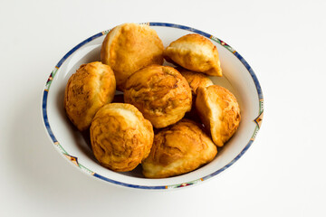 Traditional Turkish Deep Fried Dough in large bowl on white background with copy space.