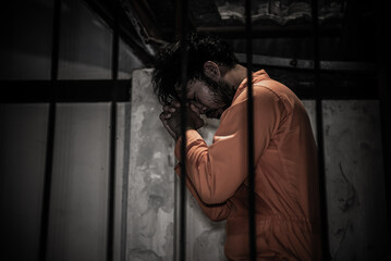 Asian man desperate at the iron prison,prisoner concept,thailand people,Hope to be free,Serious...