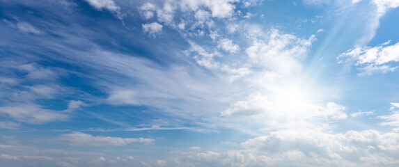 Naklejka na ściany i meble blue sky with white clouds and sun light background