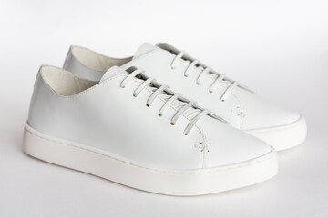classic white women's leather sneakers isolated on a white background