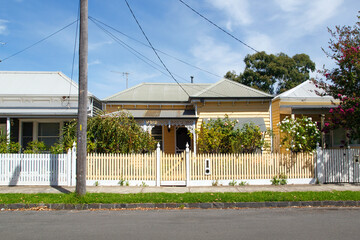  Traditionally built row of bungalow cottages in the 20th century Australian style with painted...