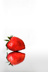 strawberry with a mirror image on a white background with a place to insert text