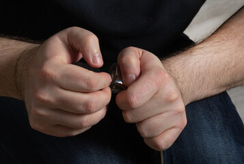 wheel from chair in hands of man.  Man is repairing chair. Repair concept