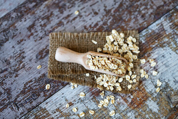 Oatmeal in a wooden spatula. Selective focus. Macro.