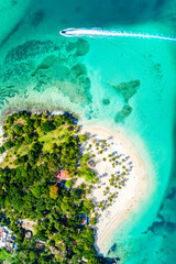 Aerial drone view of beautiful caribbean tropical island Cayo Levantado beach with palms and boat. Bacardi Island, Dominican Republic. Vacation background.