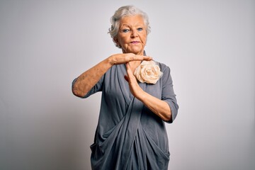 Senior beautiful grey-haired woman wearing casual dress standing over white background Doing time...