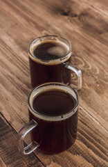Two glass cup of coffee on rustic textured wooden background. Minimal concept. Top view.