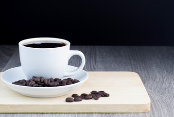 black coffee with coffee bean on wooden table
