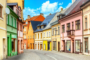 Fototapeta premium Small town narrow street view with colorful houses in Loket, Bohemia during sunny day. Czech Republic old town.