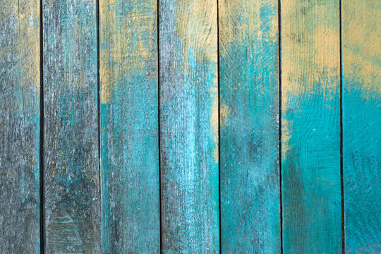 grunge wooden backgrounds - perfect background with space for text or image, blue with yellow. Stains of paint on a wooden texture. Place for advertising. Blue painted wood texture