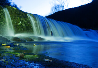 Fototapeta premium view on waterfall while playing with flashlight