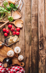 Cooking utensils and ingredients for Italian Cuisine on wooden table. Top view
