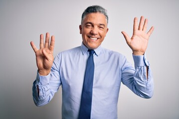 Middle age handsome grey-haired business man wearing elegant shirt and tie showing and pointing up with fingers number nine while smiling confident and happy.