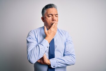 Middle age handsome grey-haired business man wearing elegant shirt and tie bored yawning tired covering mouth with hand. Restless and sleepiness.