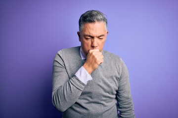 Middle age handsome grey-haired man wearing elegant sweater over purple background feeling unwell and coughing as symptom for cold or bronchitis. Health care concept.