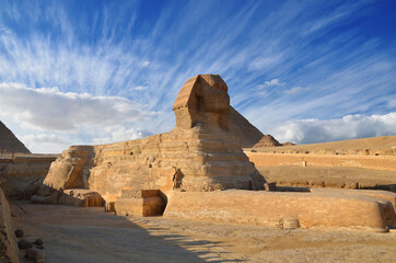 Great Sphinx against the blue sky with white clouds